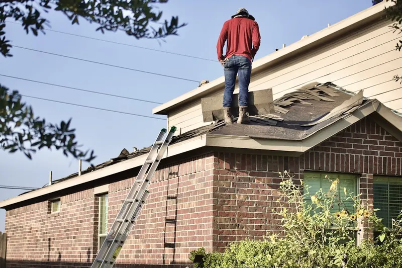 Professional roofer working on a residential roof in Jayhawk